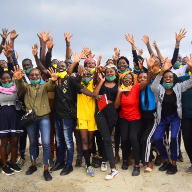 Group of Cameroonian youth pose with their hands raised